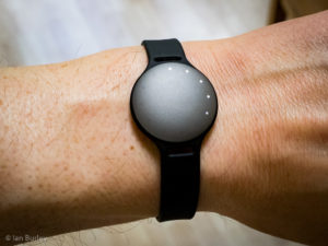 A Misfit Shine fitness activity tracker with five of its twelve LEDs shining.